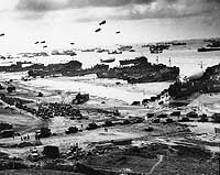 Photo # 26-G-2517:  Landing ships put cargo ashore at low tide, during the first days of the invasion of Normandy, June 1944