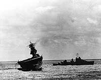 Photo # 80-G-17061:  USS Yorktown being abandoned by her crew after she was hit by two Japanese aerial torpedoes, 4 June 1942