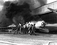 Photo # 80-G-32836: PBY patrol plane burns during Japanese air attack on NAS Kanoehe Bay, Hawaii, 7 Dec. 1941