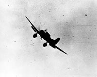 Photo # 80-G-32908:  Japanese bomber in action during the Pearl Harbor attack, 7 December 1941