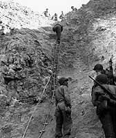 Photo # 80-G-45716:  Army Rangers show the ladders used to storm the cliffs at the Pointe du Hoc on 6 June 1944