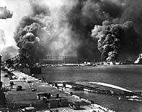 Photo # NH 80-G-474789:  View from Pier 1010, looking toward the Pearl Harbor Navy Yard's drydocks, with the capsized USS Oglala in the foreground, 7 December 1941