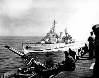 Photo # 80-G-633883:  British cruiser Belfast comes alongside USS Bataan, off Korean coast, May 1952