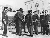 Photo # NH 52788:  TM2c Henry Breault receives the Medal of Honor from President Calvin Coolidge, 8 March 1924