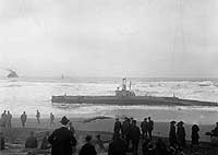 Photo # NH 53830:  USS H-3 stranded on Samoa Beach, near Eureka, California, circa 7-12 January 1917, with USS Milwaukee in the distance