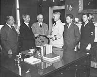 Photo # NH 55468: Secretary of the Navy Claude Swanson presents commendations to USS Akron's survivors, 1933