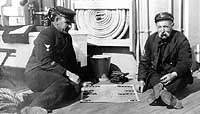 Photo # NH 101372: Two Chief Petty Officers enjoy a game of 'Acey-Deucy' on board USS Baltimore, circa 1904-1906'