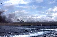 Photo # NH 104319-KN: Explosions and fires on Iwo Jima, probably during the pre-landing bombardment, circa 19 February 1945.  Photographed by Lt. Howard W. Whalen, USNR