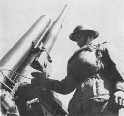 Plate 2. Preparing to fire a 3-7-inch Mark II Anti-Aircraft Gun (Static Mounting).