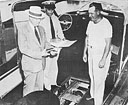 Mr. Calvin H. Calby, Director of Public Safety, Norfolk, Virginia, 
checks fire extinguisher, as interesting spectator looks on, 
while Mr. Fred Swink, Training Officer, Flotilla #52, prepares data of 
courtesy inspection aboard the Yacht Tempie berthed Southern Yacht Marine, Norfolk, Va.